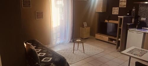 a living room with a couch and a television at Marinas Apartments Alexandroupolis in Alexandroupoli