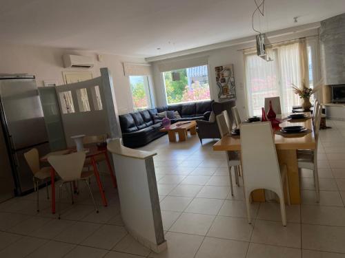 a kitchen and living room with a table and chairs at Diamond Maisonette in Kavála