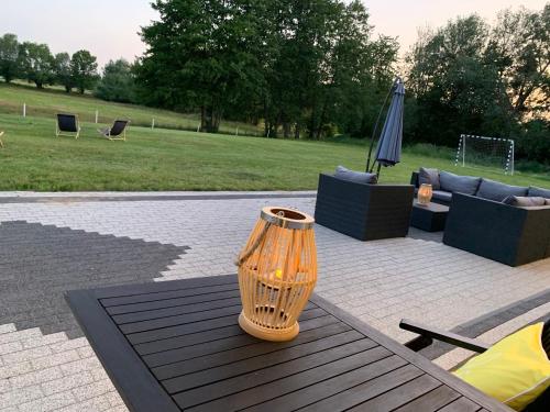 a vase sitting on top of a wooden table at Dworek Pod Wierzbami 