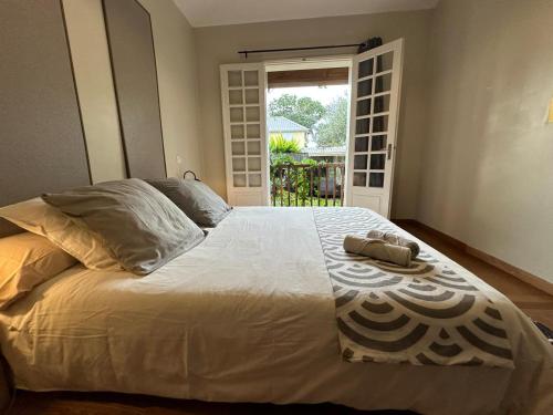 a bedroom with a bed with a towel on it at Chambre Zoizo Paradis in Saint-André