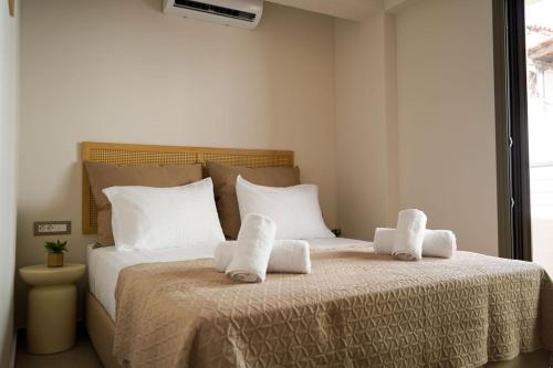 a bedroom with a bed with towels on it at Afali City Center apartments in Zakynthos Town