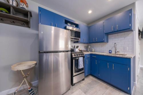 a kitchen with blue cabinets and a stainless steel refrigerator at Studio Suite B1 in Bridgman