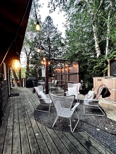 a group of chairs and tables on a wooden deck at The Muskoka Nest in Windermere