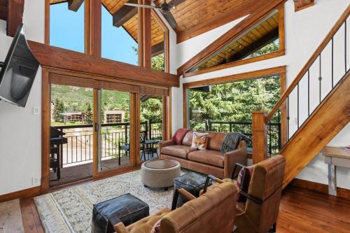 a living room with leather furniture and large windows at Crestwood 1303 Deluxe 1 Bedroom plus Loft in Snowmass Village