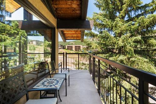 a balcony of a house with benches and trees at Crestwood 1303 Deluxe 1 Bedroom plus Loft in Snowmass Village