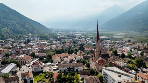 an aerial view of a town with a church tower at New Residence Schnatzhof Schlanders in Silandro