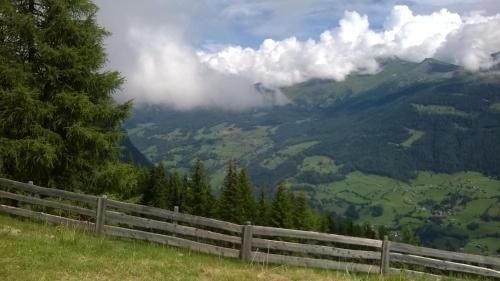 a fence on a hill with a view of a mountain at Haus Rupitsch in Winklern
