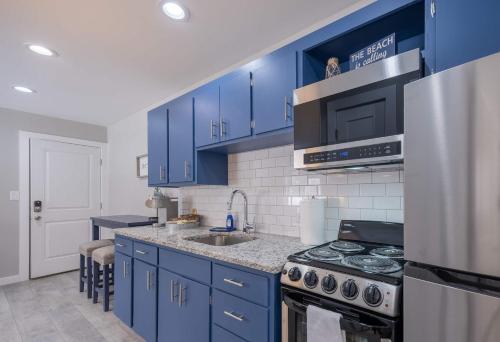 a kitchen with blue cabinets and a sink and a stove at Sunset Villa B5 in Bridgman