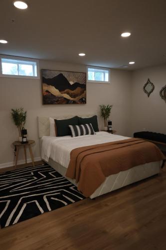 a bedroom with a large bed and a rug at Ultra Luxe 2B Basement Apartment in Lanham