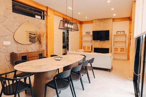 a living room with a table and chairs and a couch at Cozy big house in Paracas