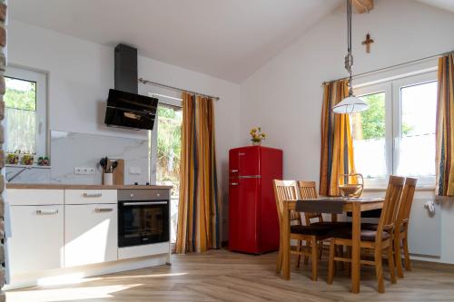a kitchen with a table and a red refrigerator at LOFT 2 in Thürnthal