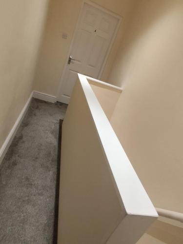 a white staircase in a room with a door at En-Suite Double-Bedroom in the Heart of Salford Manchester CR3 Perfect for Short Stays in Manchester