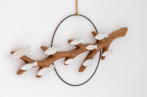 a wooden branch christmas ornament with birds on it at Le Léon 13 Joli studio avec balcon situé à Dieppe in Dieppe