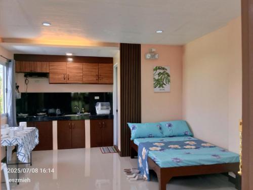 a living room with a couch and a kitchen at Megan and Angel Travellers Inn in Sinai