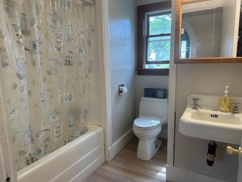 a bathroom with a toilet and a sink and a shower at Sawyer Cove Cottage in Jonesport