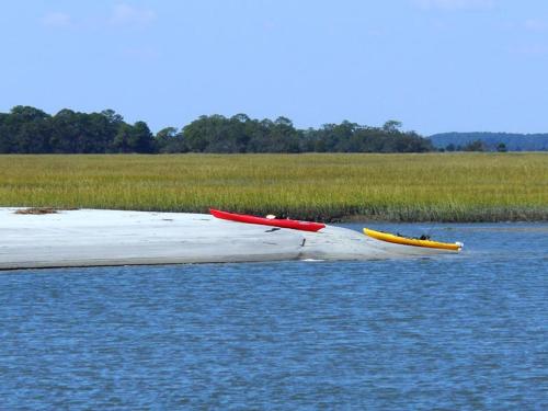 two kayaks sitting on a raft in the water at Cozy Suite just Steps from Beach Club, Sandbar, Tennis, & Beaches in Fripp Island