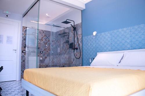 a bedroom with a large bed and a shower at San Carlo Cuore di Palermo in Palermo