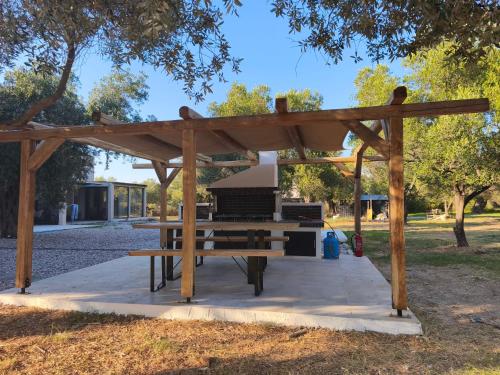 a picnic table under a wooden pavilion in a park at Elaida suites in Prinos