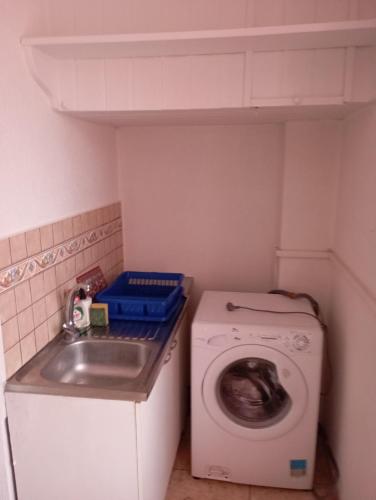 a small kitchen with a washing machine and a sink at Chambre 2 à louer à Bienne in Biel