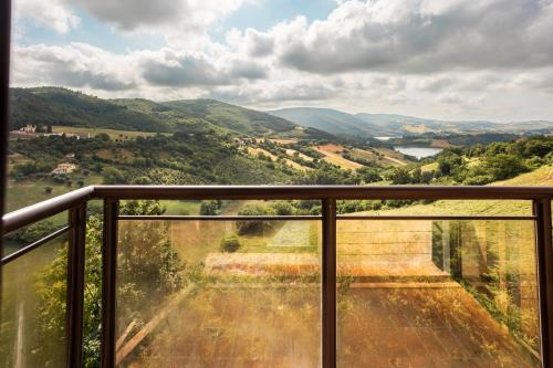 a view of a valley from a balcony at Hotel Eldorado in Apiro