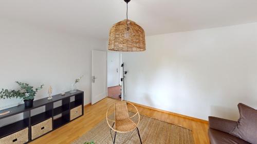 a living room with a couch and a chair at Basic Comforts for Your Stay in Zürich