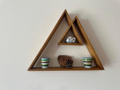 a wooden shelf with three vases on a wall at Appartement lumineux avec terrasse & Wifi à Verchaix - FR-1-642-82 in Verchaix