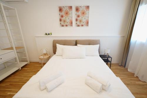 a bedroom with a white bed with white pillows at La Marina Case Vacanze in Augusta