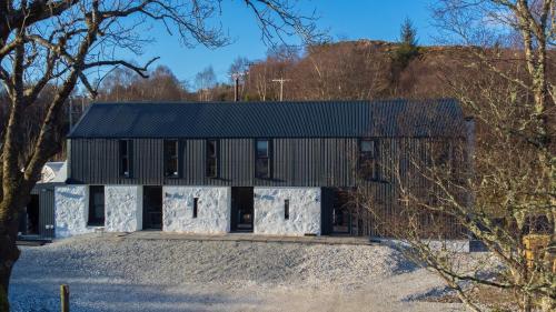 a building with a black and white facade at Old Kyle Farm - Stunning Views - 2 mins from Skye Bridge in Kyleakin