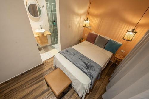 a small bedroom with a bed and a bathroom at La Martina Boutique Hotel in Medellín