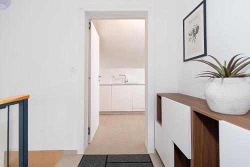 a hallway with white walls and a bathroom with a sink at Luxury apartments Lun in Lun