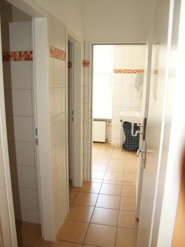 a bathroom with a toilet and a sink at Happy Go Lucky Hotel + Hostel in Berlin
