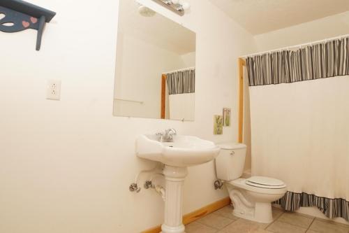 a bathroom with a sink and a toilet and a mirror at Ranchette Ponderosa - The Nebo #3 at Wind Walker Homestead in Spring City