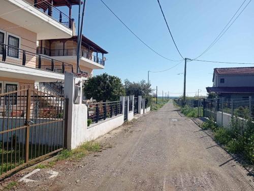 an empty dirt road next to a building at Sea View Maisonette just 250m from the Beach Fully Equipped & Spacious! in AgiaKampos