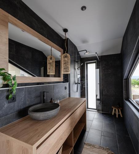 a bathroom with a wooden counter and a sink at Kosa Estate in Štúrovo