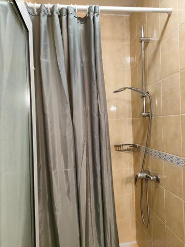 a shower with a shower curtain in a bathroom at VILLA JURAS in Podstrana
