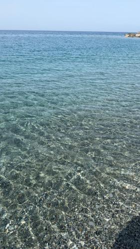 a large body of water with rocks in it at La casa dei tre platani in Case Torre di Sacco
