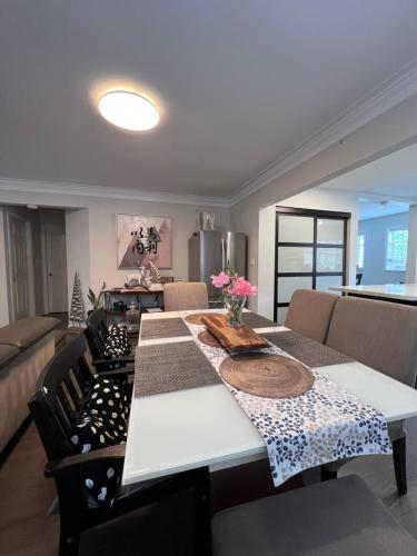a living room with a table and a couch at Vancouver Airport 7 mins away Cozy room Richmond near YVR in Richmond