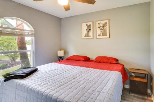 a bedroom with a bed with red pillows and a window at 5 Mi to Highlands Hammock Oasis with Heated Pool! in Sebring