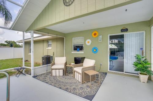 a covered patio with two chairs and a desk at 5 Mi to Highlands Hammock Oasis with Heated Pool! in Sebring
