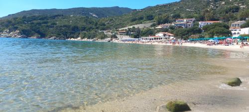 a beach with a group of people on the shore at Detached house in San Piero in Campo, Elba Island in San Piero in Campo