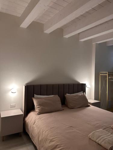 a bedroom with a large bed with two pillows at B&B re apartments Palazzo Muscati in Molfetta