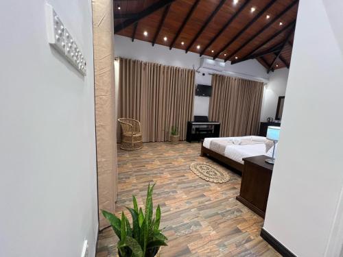 a bedroom with a bed and a living room at Villa Sole in Kandy