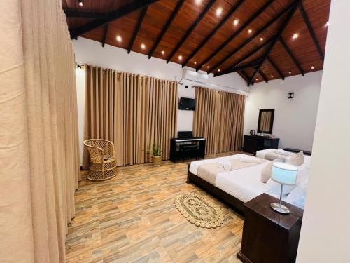 a bedroom with a bed and a desk in it at Villa Sole in Kandy