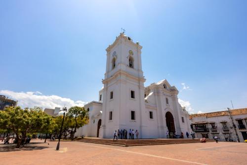 a large white building with a clock tower at Mercure Santa Marta Emile in Santa Marta