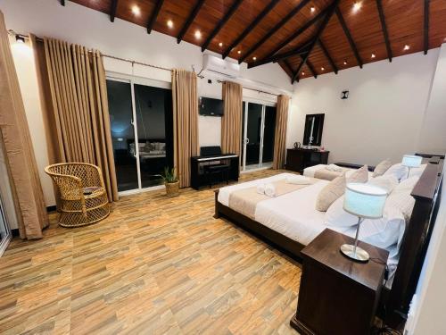 a large bedroom with a large bed and a desk at Villa Sole in Kandy