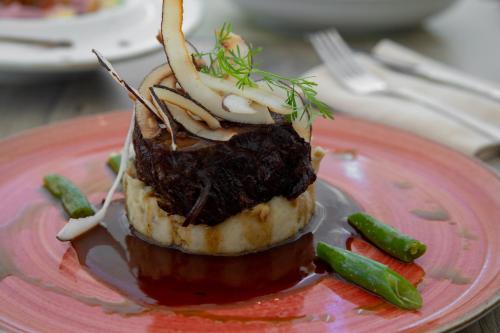 a piece of food on a pink plate at Mercure Santa Marta Emile in Santa Marta