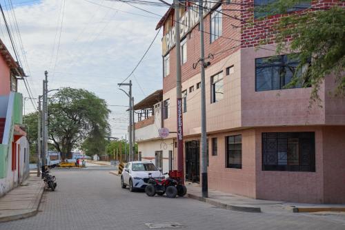 a white car parked on a street next to a building at Hospedaje Los Organos in Los Órganos