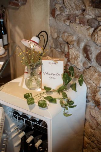 a table with a sign and a vase with flowers at Dimora Buglioni Wine Relais in San Pietro in Cariano