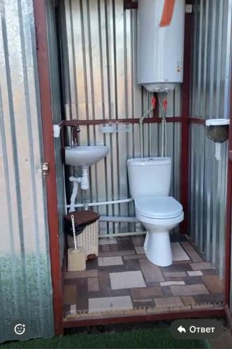 a bathroom with a toilet and a sink at Волна in Balqash
