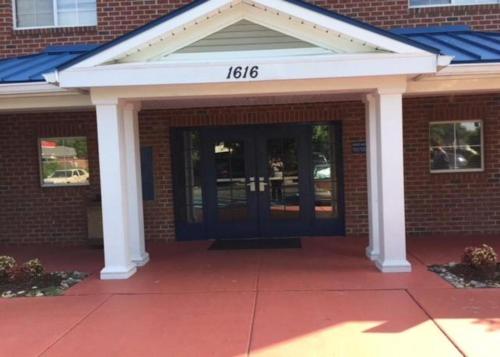 a front door of a brick building with the number at Studio 6-Hampton, VA - Langley AFB Area in Hampton